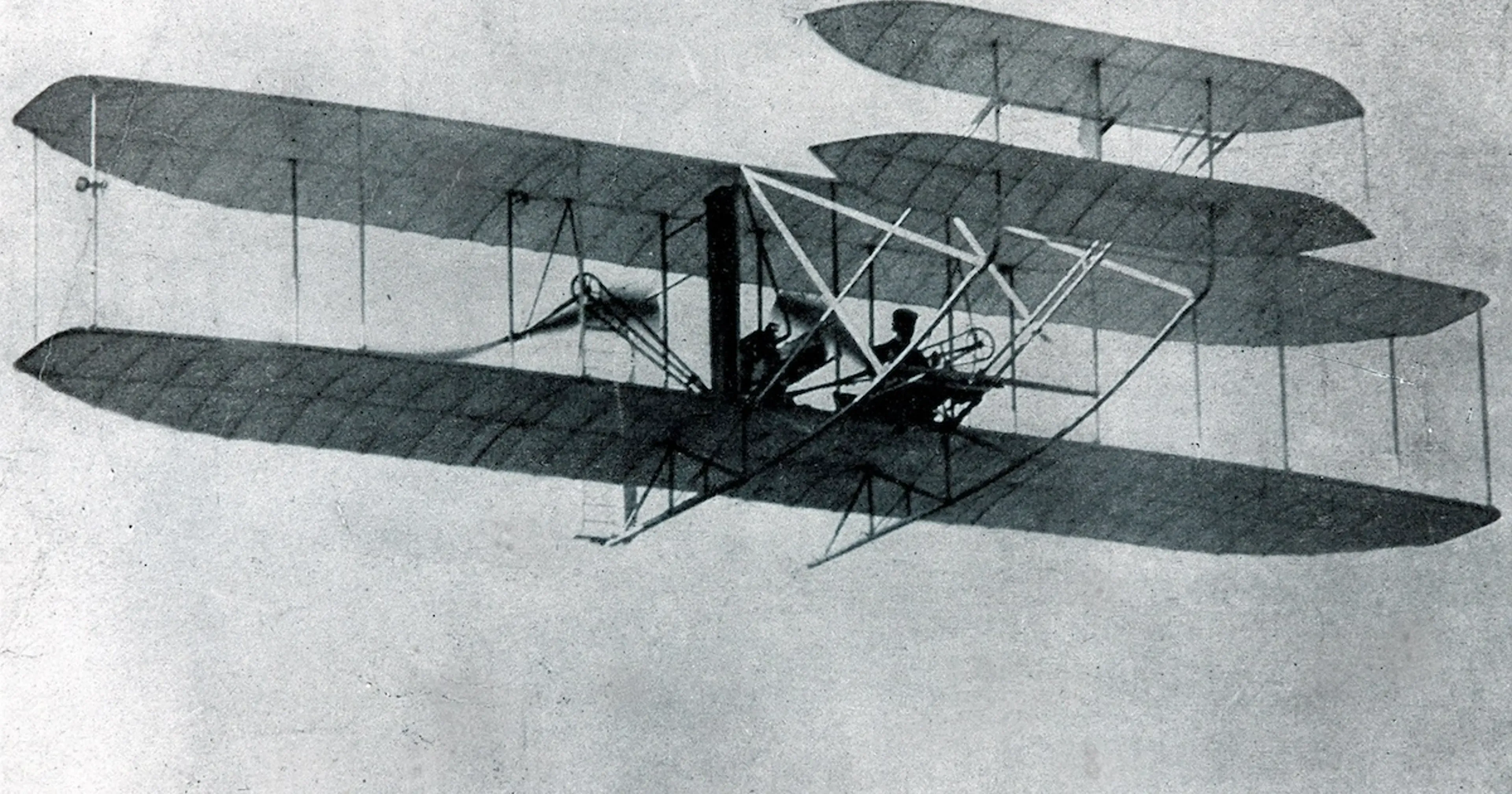John T. Daniels’s photograph of the first powered flight at Kill Devil Hills, December 17, 1903, with Orville at the controls and Wilbur running alongside.